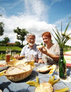 Foto: Paar mit Essen im Biergarten Groggensee Foto: Paar mit Essen im Biergarten Groggensee